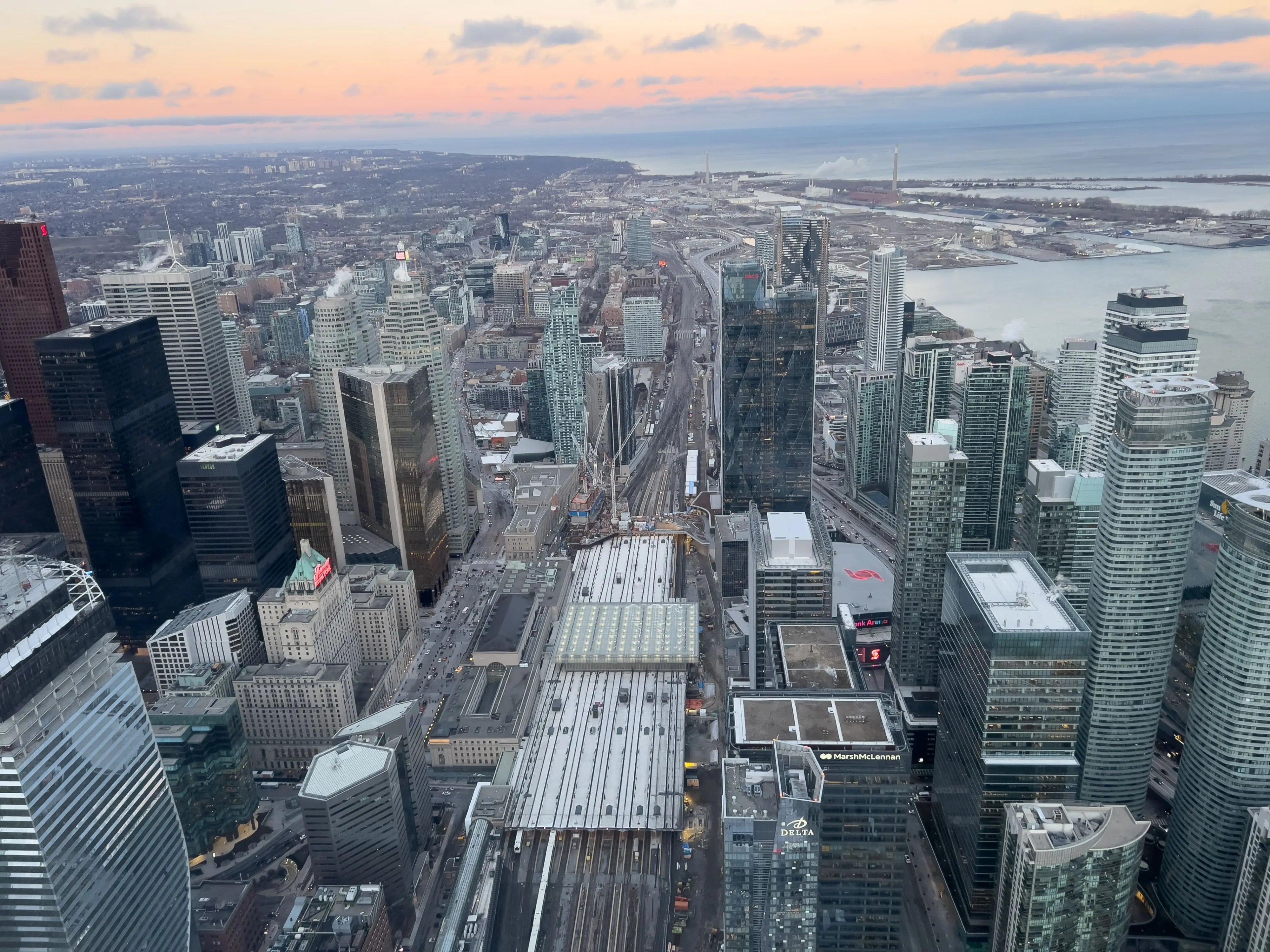 a top view of the toronto skyline, featuring the CN tower with corporate buildings in the background